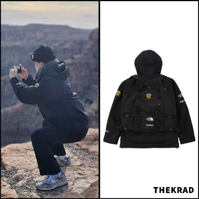 BTS Suga does a squat in scenic canyons wearing supreme x TNF jacket